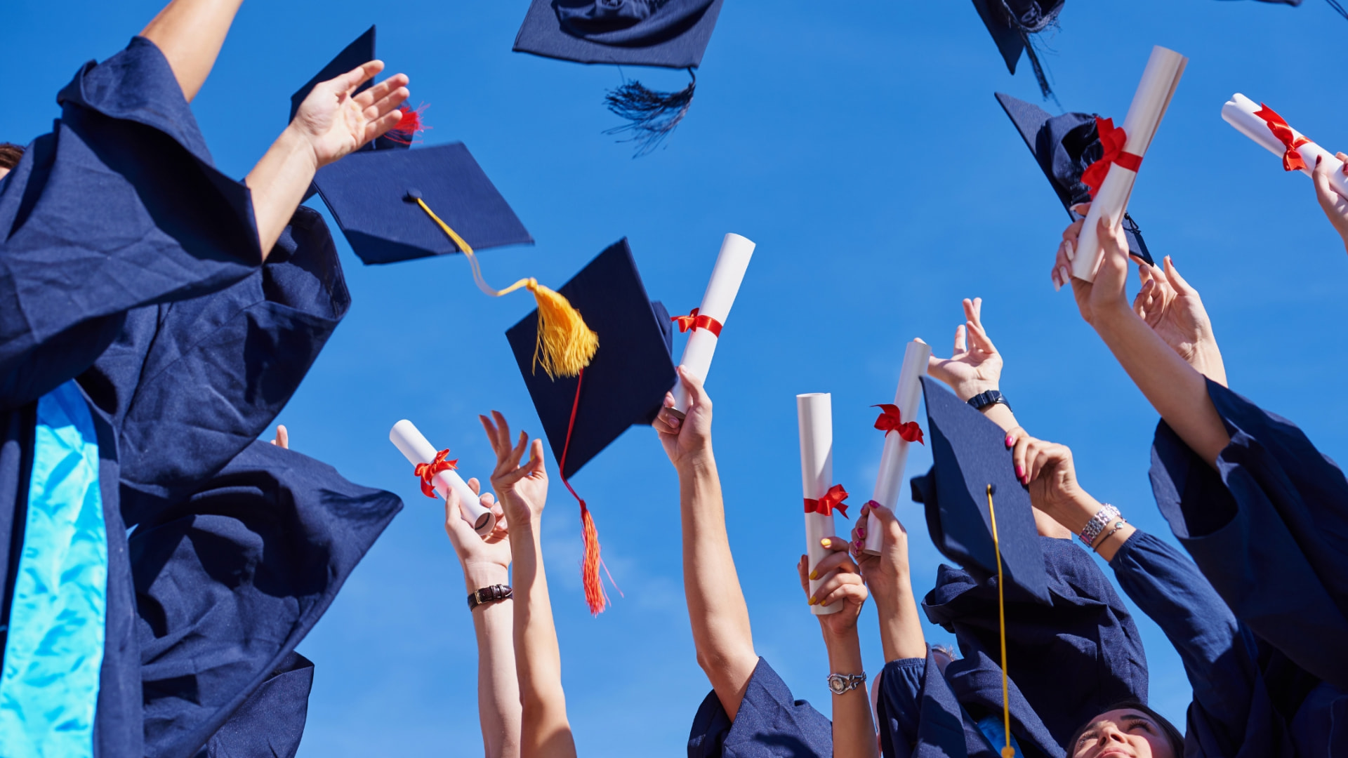 Graduates throwing their caps into the sky